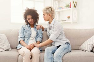 Dealing-With-Difficult-Behaviors Consoling Friend on Couch