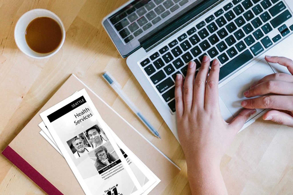 Hands At Keyboard with Brochures